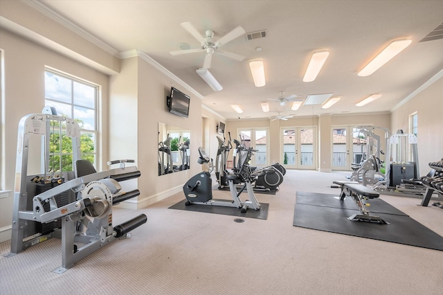 workout area with crown molding, light colored carpet, and ceiling fan