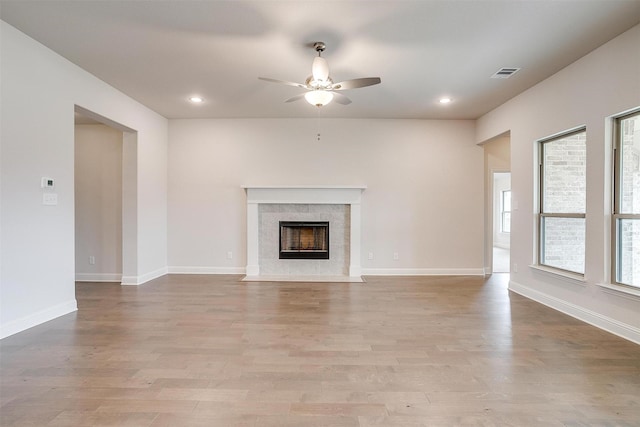 unfurnished living room featuring ceiling fan and light hardwood / wood-style flooring