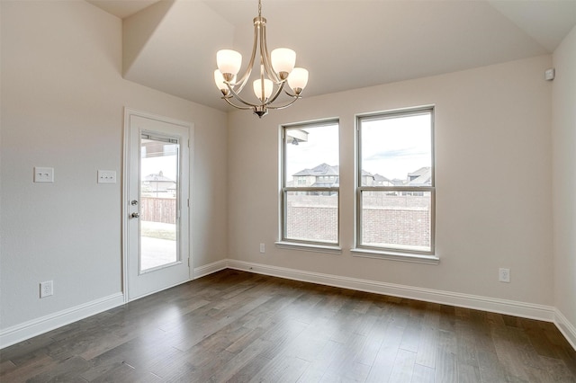 interior space with dark wood-type flooring and a notable chandelier