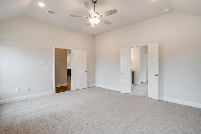 unfurnished bedroom with vaulted ceiling, ceiling fan, and light carpet