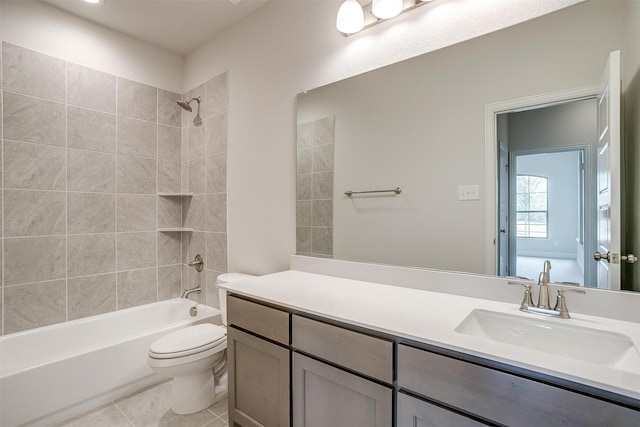 full bathroom featuring tiled shower / bath combo, vanity, toilet, and tile patterned flooring