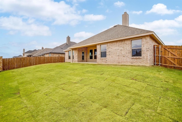 back of house featuring a yard