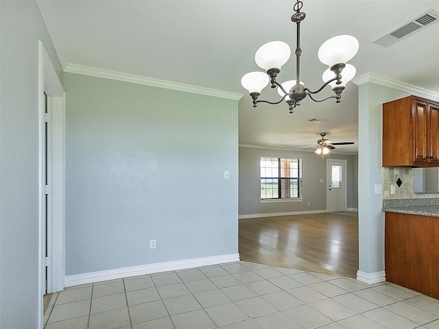 kitchen featuring decorative backsplash, ceiling fan with notable chandelier, decorative light fixtures, and ornamental molding