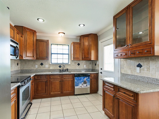 kitchen with light stone countertops, sink, appliances with stainless steel finishes, and ornamental molding