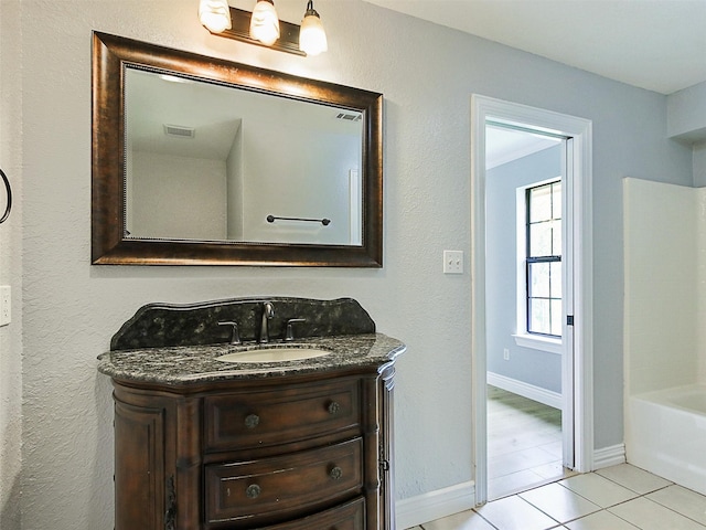 bathroom featuring tile patterned flooring and vanity