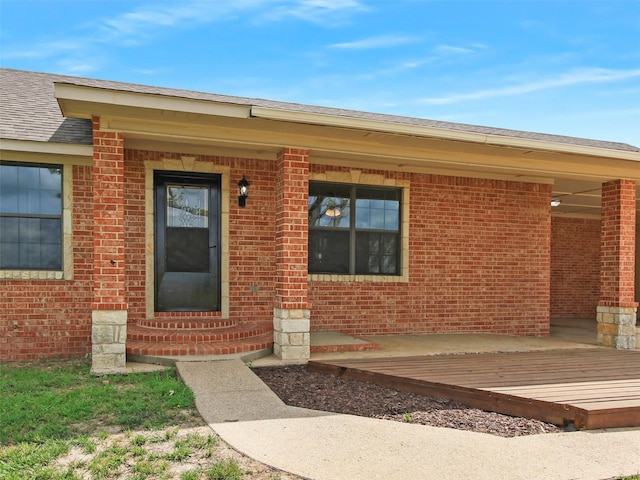 view of exterior entry featuring covered porch