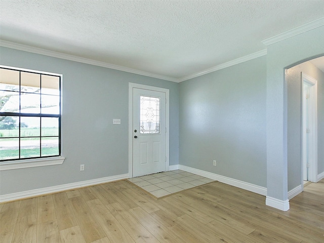 entryway with crown molding, a textured ceiling, and light wood-type flooring