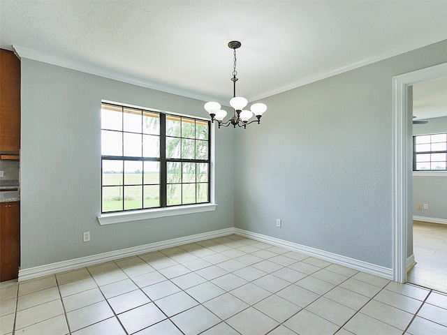 unfurnished dining area featuring crown molding, light tile patterned floors, and an inviting chandelier