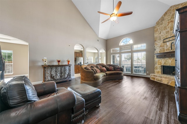 living room with ceiling fan, dark hardwood / wood-style flooring, a fireplace, and high vaulted ceiling