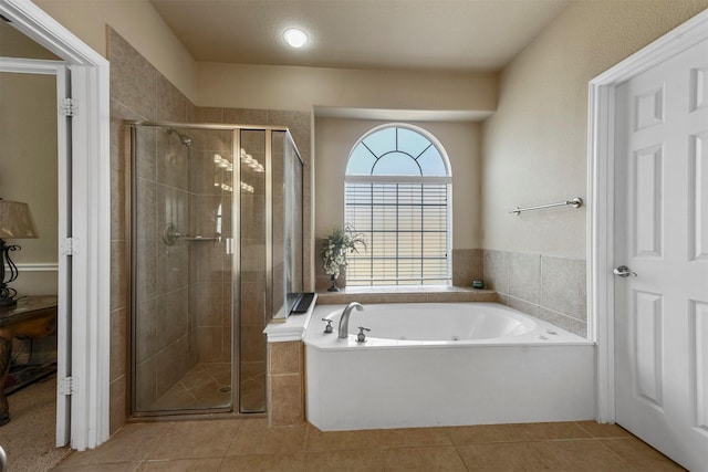 bathroom featuring tile patterned floors and shower with separate bathtub