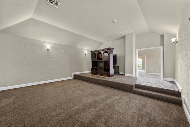 unfurnished living room featuring lofted ceiling and carpet floors