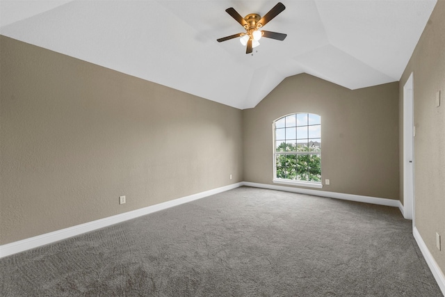 carpeted spare room with vaulted ceiling and ceiling fan