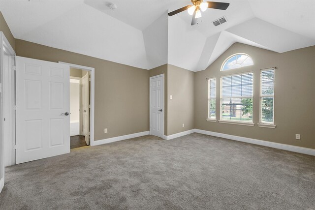 unfurnished bedroom with ceiling fan, light colored carpet, and vaulted ceiling