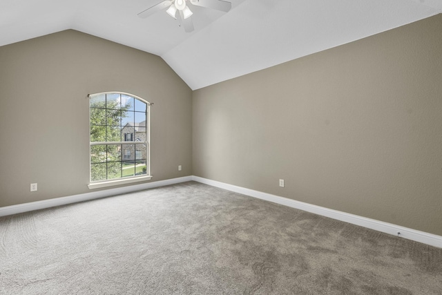 carpeted empty room featuring ceiling fan and lofted ceiling