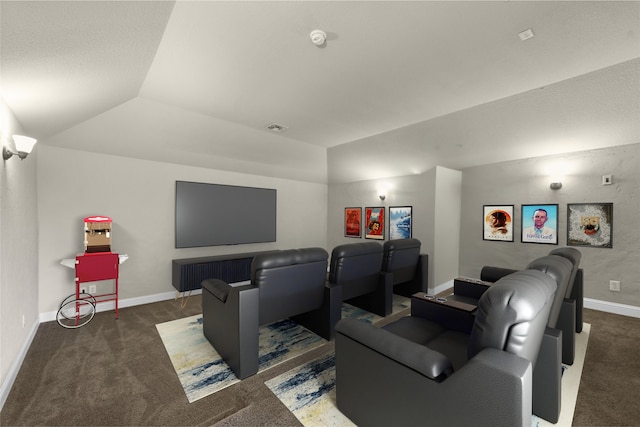 carpeted home theater featuring lofted ceiling and a tray ceiling