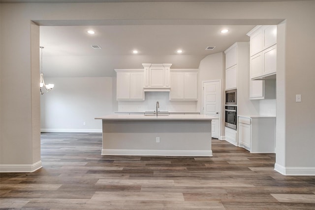 kitchen featuring sink, appliances with stainless steel finishes, dark hardwood / wood-style flooring, and white cabinetry