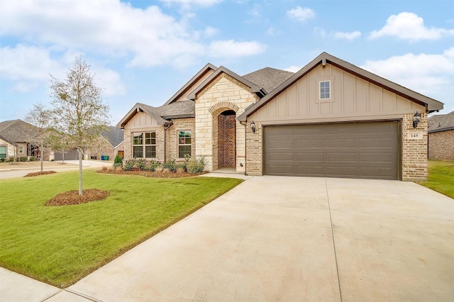 view of front of house with a garage and a front lawn