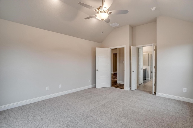 unfurnished bedroom with ceiling fan, light carpet, and vaulted ceiling