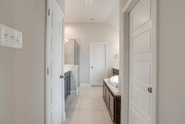 bathroom with vaulted ceiling, tile patterned floors, and plus walk in shower