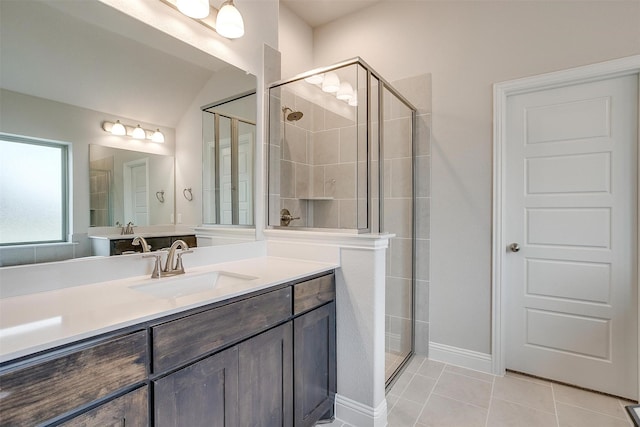 bathroom featuring tile patterned floors, an enclosed shower, and vanity