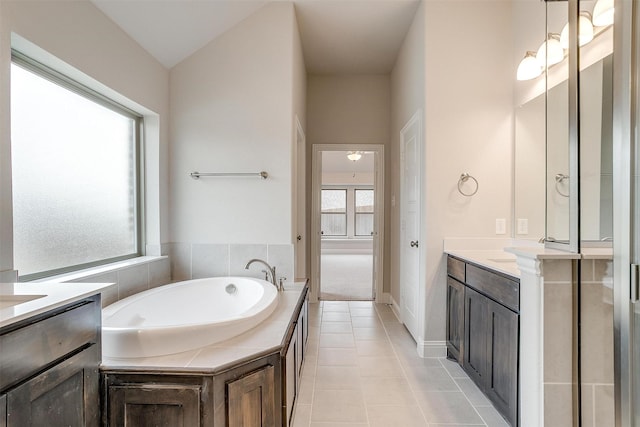 bathroom with a bath, tile patterned floors, and vanity