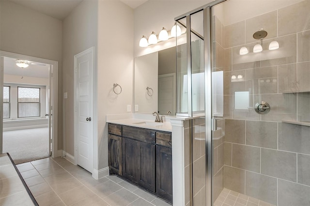 bathroom with tile patterned floors, vanity, and a shower with shower door