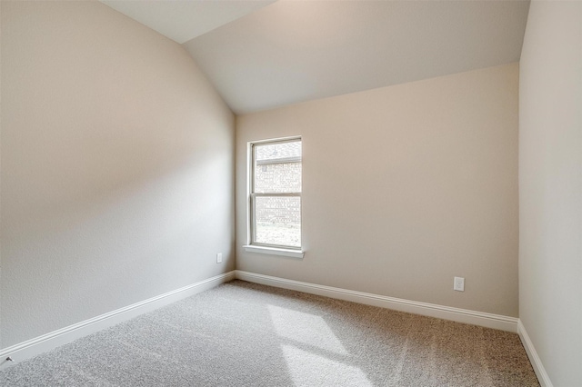 unfurnished room with carpet floors and lofted ceiling