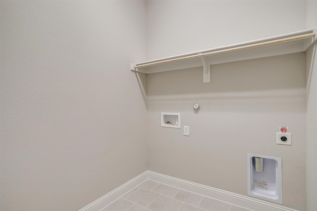 clothes washing area featuring tile patterned floors, hookup for an electric dryer, hookup for a washing machine, and gas dryer hookup