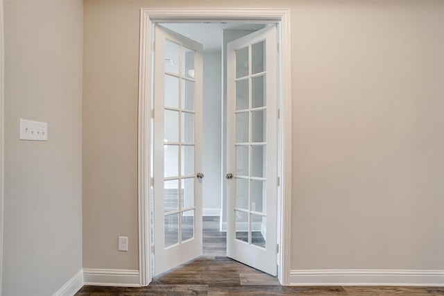 entryway with dark hardwood / wood-style floors and french doors