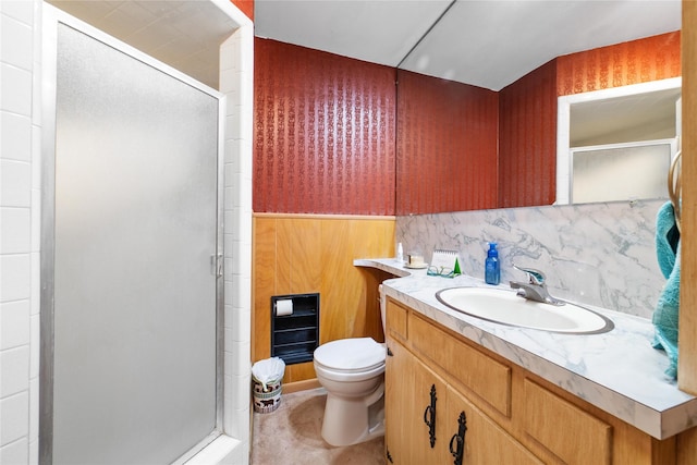 bathroom with decorative backsplash, toilet, a shower with door, and vanity