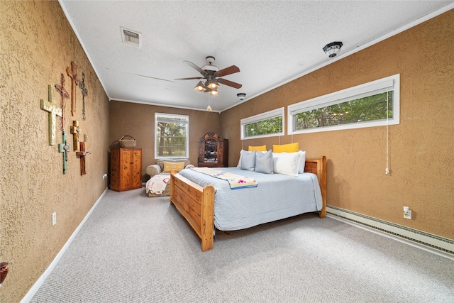 carpeted bedroom featuring a textured ceiling, ceiling fan, crown molding, and baseboard heating