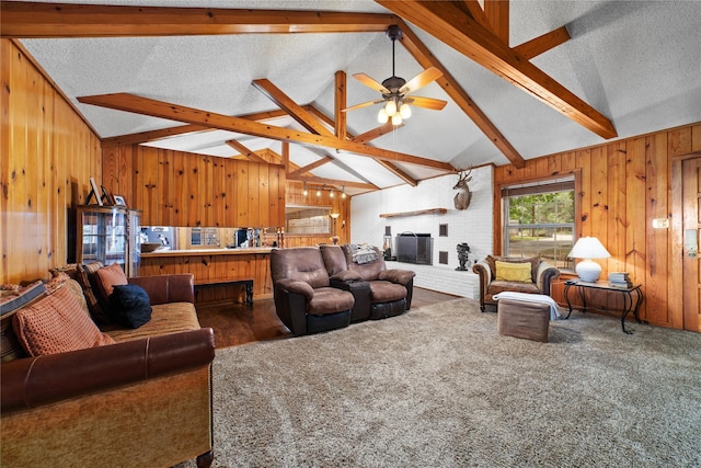 carpeted living room with vaulted ceiling with beams, ceiling fan, a textured ceiling, and a brick fireplace