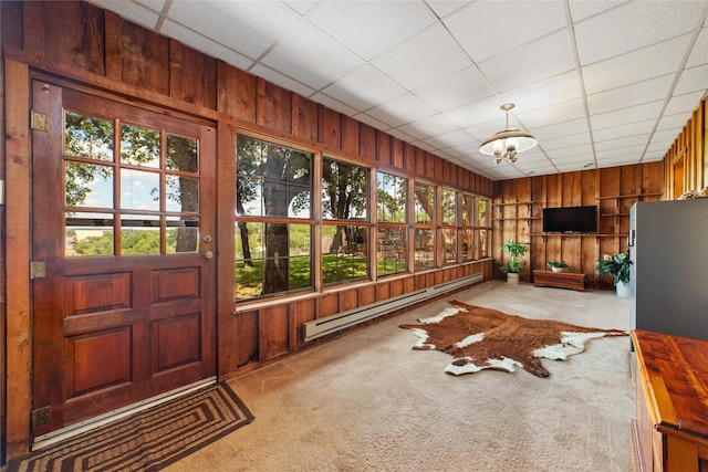 sunroom / solarium featuring a paneled ceiling, an inviting chandelier, and a baseboard heating unit