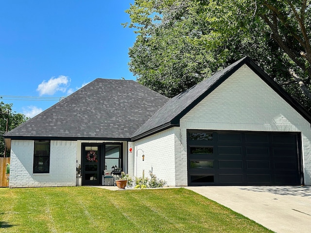 view of front of property with a front yard and a garage