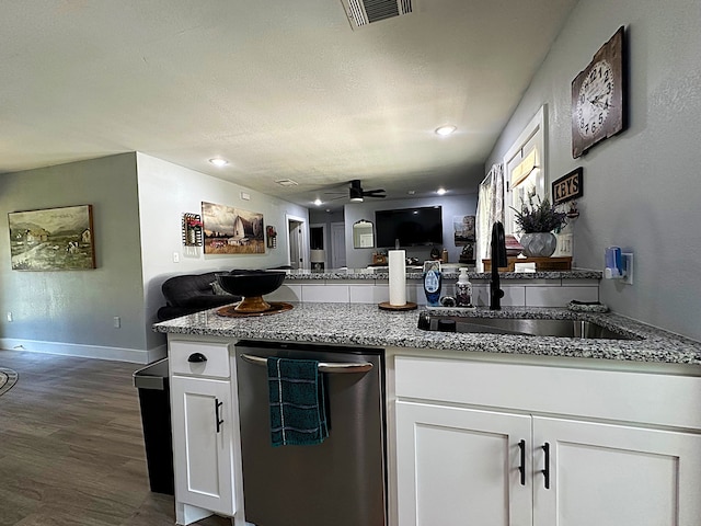 kitchen with ceiling fan, hardwood / wood-style floors, white cabinetry, stainless steel dishwasher, and sink