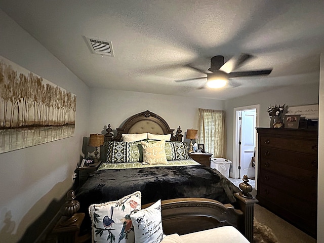 carpeted bedroom with a textured ceiling and ceiling fan