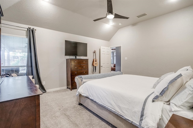 bedroom with light colored carpet, visible vents, a ceiling fan, vaulted ceiling, and baseboards