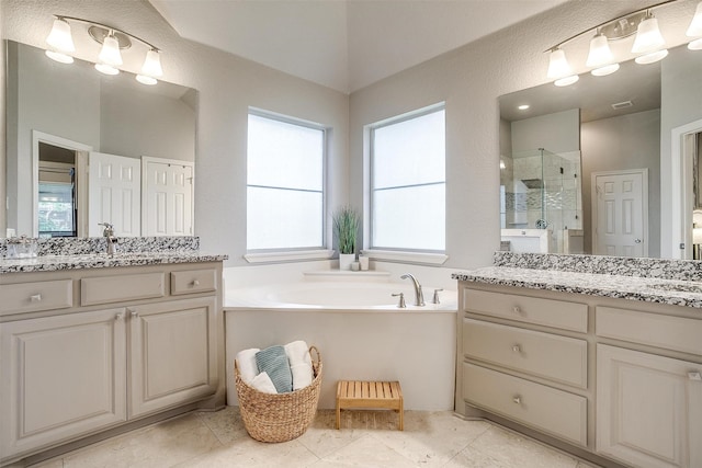 bathroom with two vanities, a sink, a shower stall, and a bath