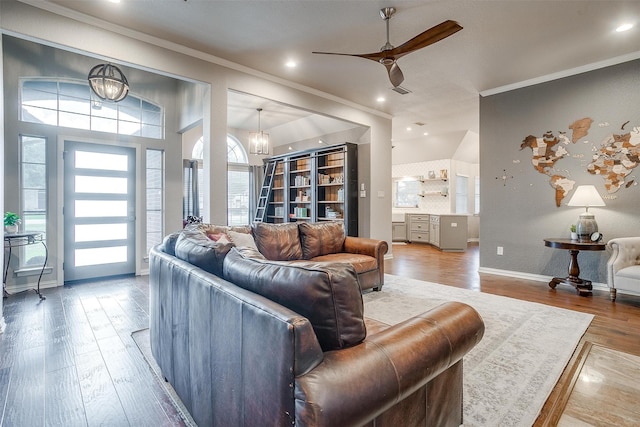 living room featuring ceiling fan with notable chandelier, crown molding, and hardwood / wood-style floors