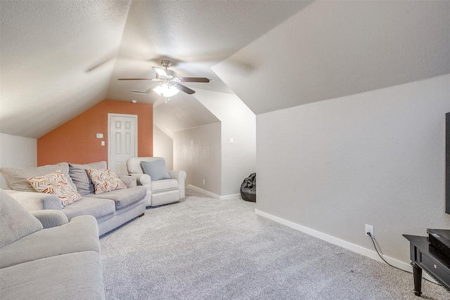 carpeted living room with lofted ceiling, ceiling fan, baseboards, and a textured ceiling