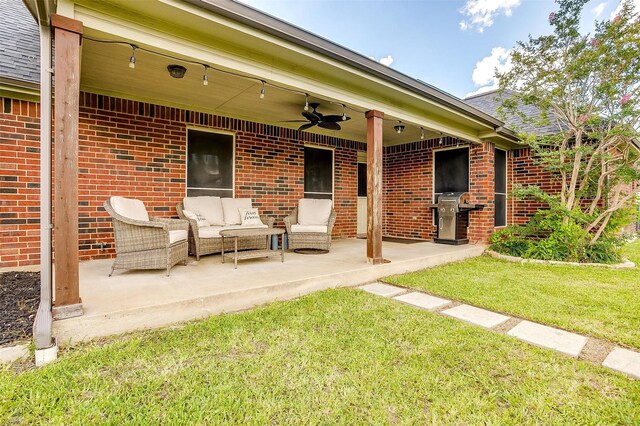 back of house featuring a ceiling fan, a patio area, brick siding, and an outdoor living space