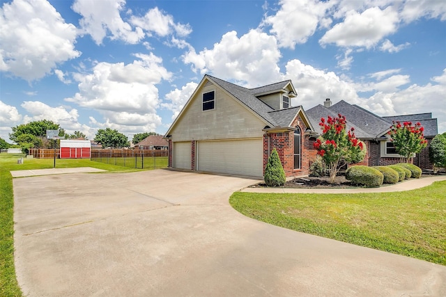 view of front of home with an attached garage, brick siding, fence, concrete driveway, and a front yard