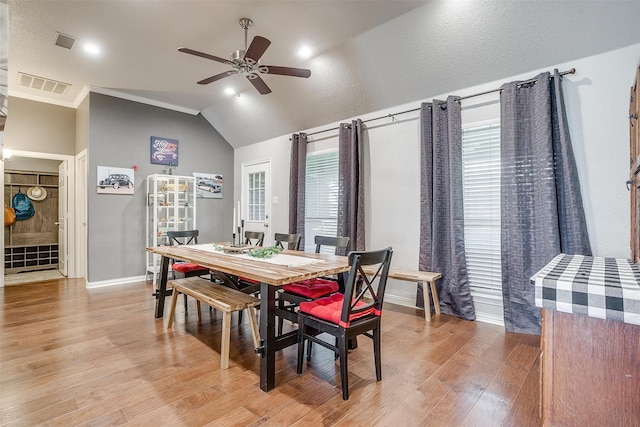 dining area with light hardwood / wood-style flooring, lofted ceiling, ceiling fan, and a healthy amount of sunlight