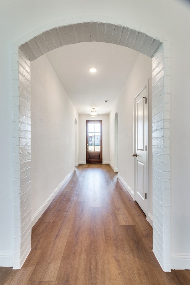 hall with hardwood / wood-style floors