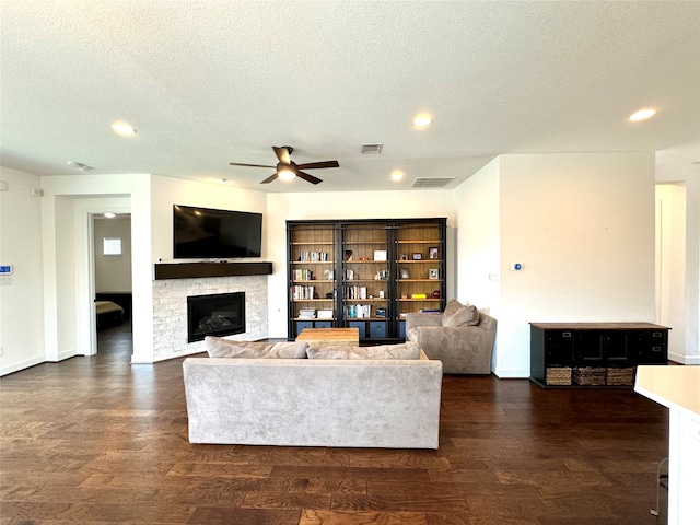 living room featuring a textured ceiling, dark hardwood / wood-style flooring, and ceiling fan