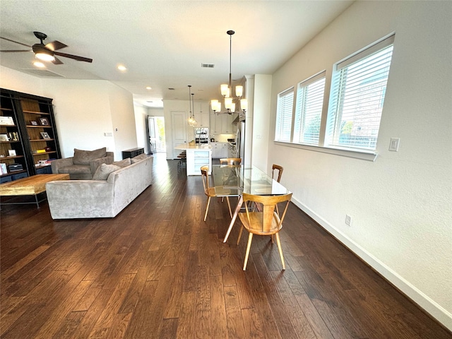 dining room with ceiling fan with notable chandelier and hardwood / wood-style floors