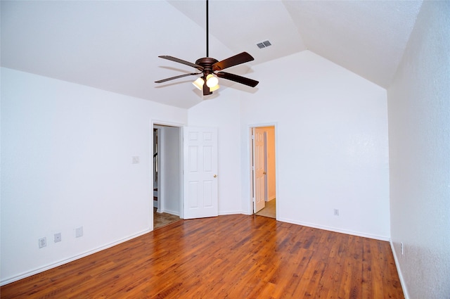 empty room with hardwood / wood-style floors, ceiling fan, and vaulted ceiling