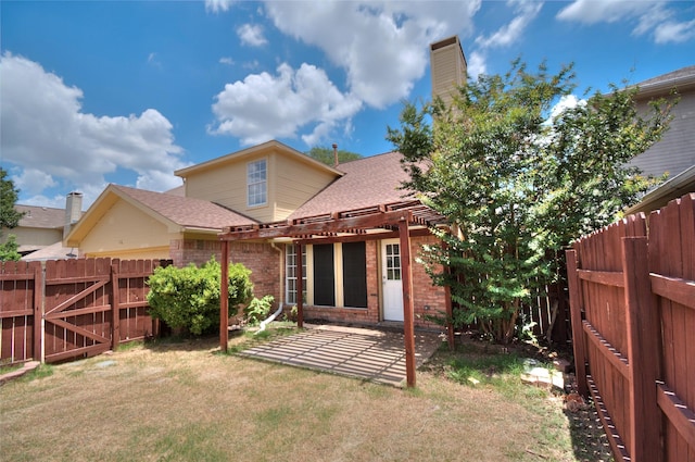 rear view of house with a patio area and a pergola