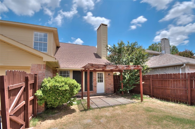 back of house with a yard and a patio area