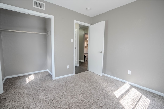 unfurnished bedroom with carpet and a closet